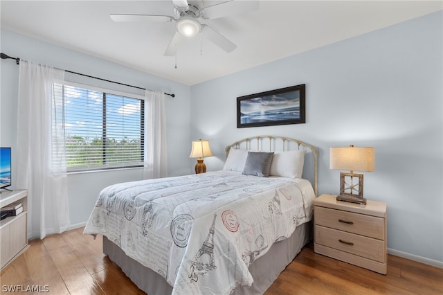 bedroom with hardwood / wood-style floors and ceiling fan