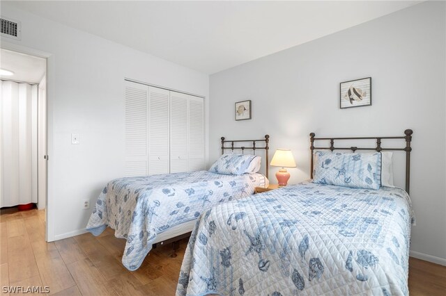 bedroom featuring a closet and light hardwood / wood-style flooring