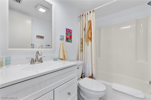 full bathroom featuring vanity with extensive cabinet space, shower / bath combination with curtain, and toilet