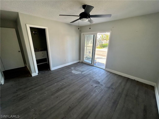 unfurnished room with a textured ceiling, dark hardwood / wood-style floors, and ceiling fan