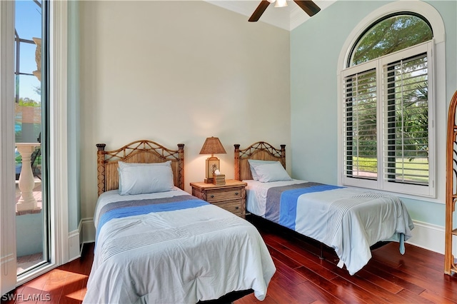 bedroom featuring dark hardwood / wood-style flooring, multiple windows, and ceiling fan