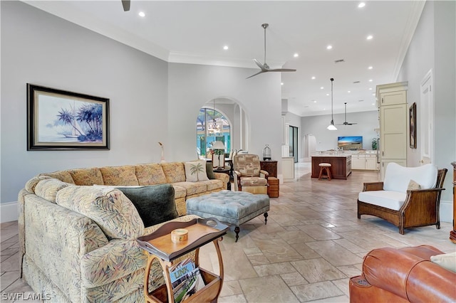 living room with crown molding, ceiling fan, and light tile floors