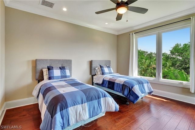 bedroom with ceiling fan, hardwood / wood-style flooring, and ornamental molding