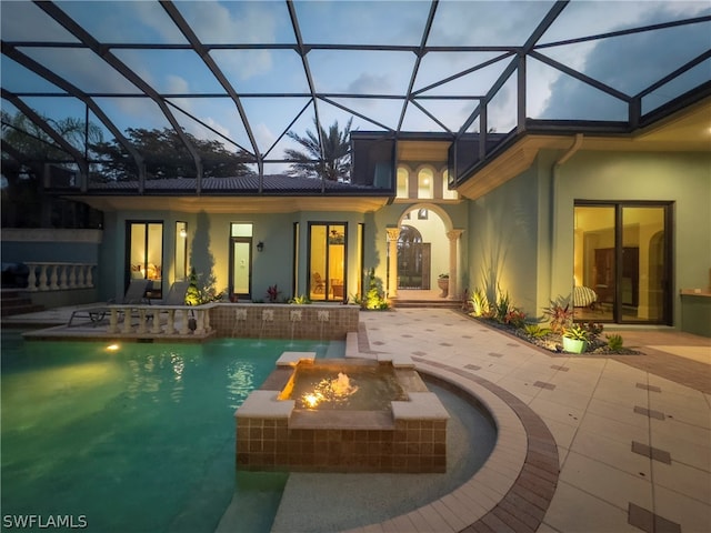 view of swimming pool featuring a patio, a fire pit, pool water feature, and glass enclosure