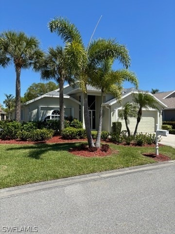 view of front facade with a garage and a front lawn