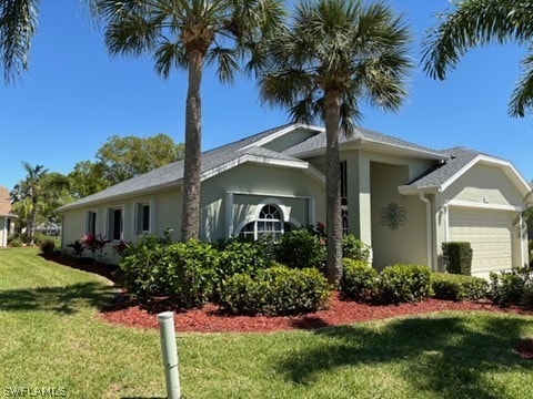 view of front facade with a garage and a front yard