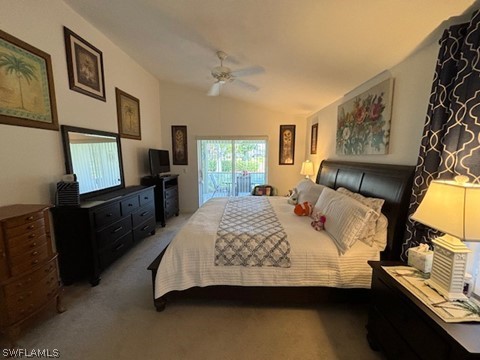 bedroom featuring lofted ceiling, ceiling fan, dark carpet, and access to outside