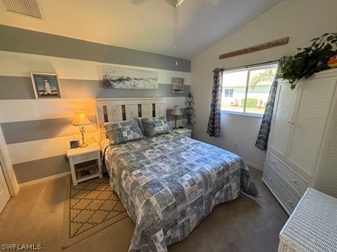 carpeted bedroom with lofted ceiling and ceiling fan