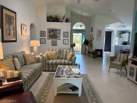 tiled living room with high vaulted ceiling