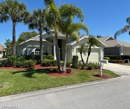 single story home featuring a front yard and a garage