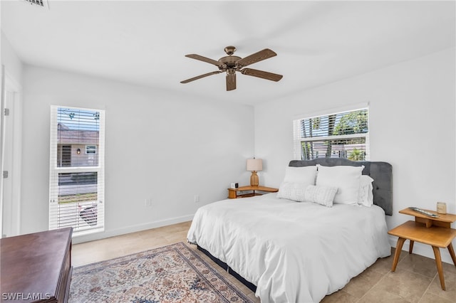 bedroom featuring ceiling fan and light tile floors