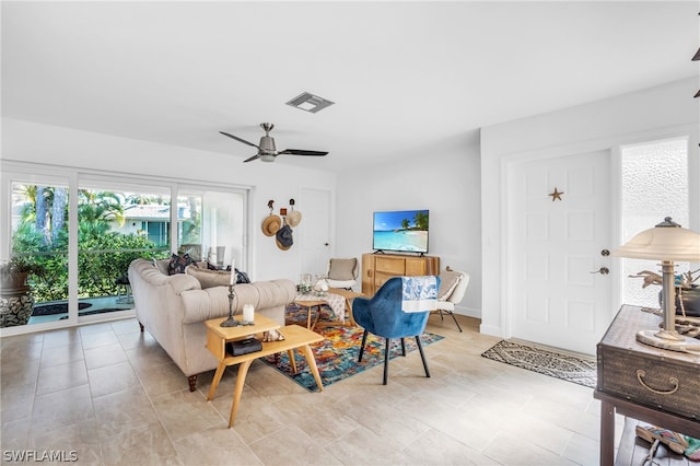 living room featuring ceiling fan and light tile floors