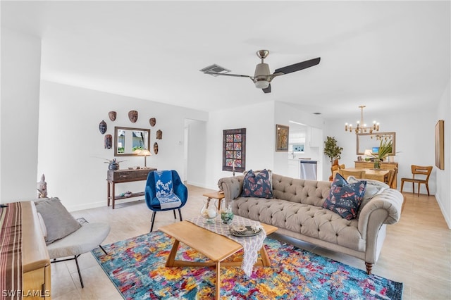 living room featuring ceiling fan with notable chandelier