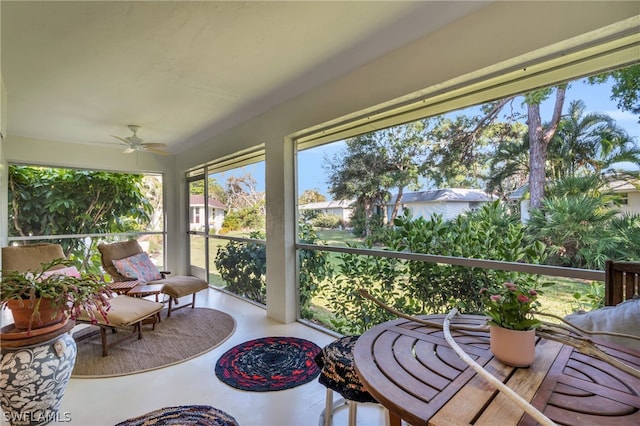 sunroom / solarium featuring ceiling fan