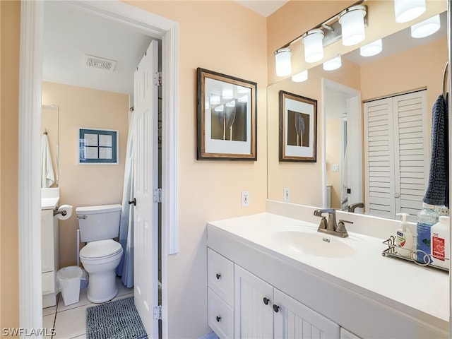 bathroom with tile flooring, oversized vanity, and toilet