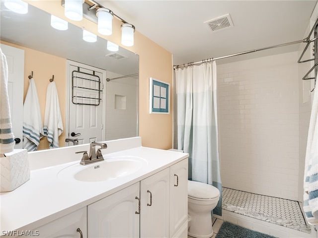 bathroom featuring a shower with shower curtain, toilet, and large vanity