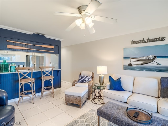 tiled living room featuring ornamental molding and ceiling fan