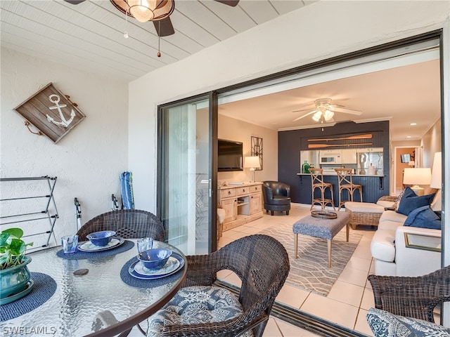 tiled dining space featuring ceiling fan