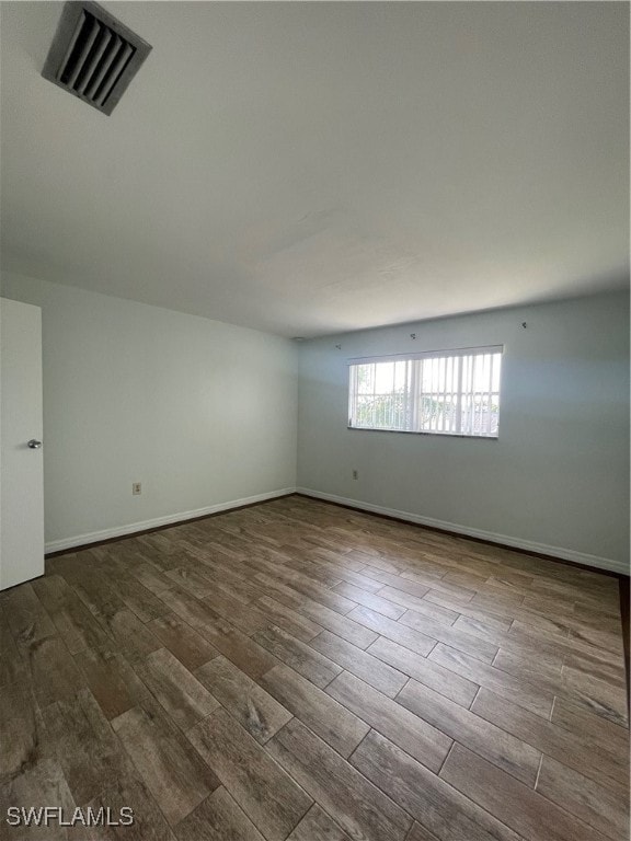 empty room with hardwood / wood-style flooring