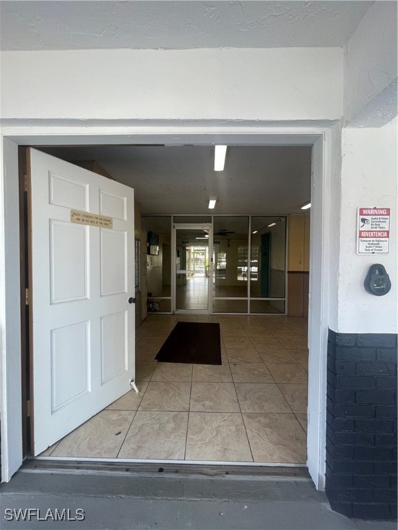 hallway with tile patterned flooring