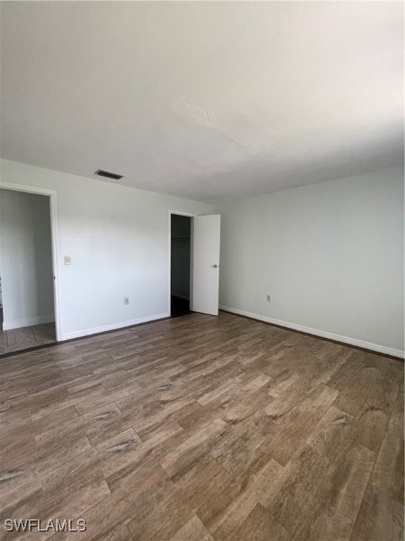 unfurnished room with wood-type flooring