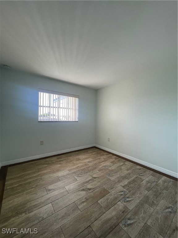 unfurnished room with wood-type flooring