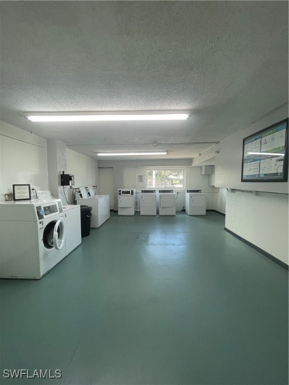 clothes washing area with a textured ceiling and washing machine and clothes dryer