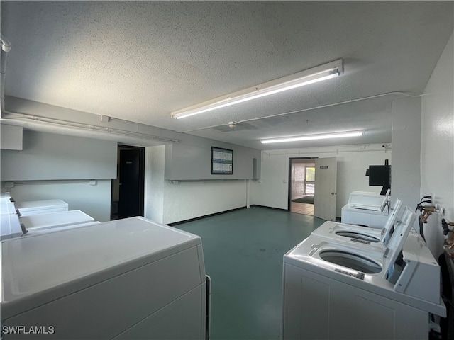 laundry room with a textured ceiling and independent washer and dryer