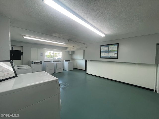 clothes washing area featuring a textured ceiling and washing machine and clothes dryer