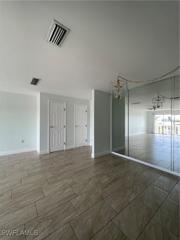 unfurnished bedroom featuring a notable chandelier