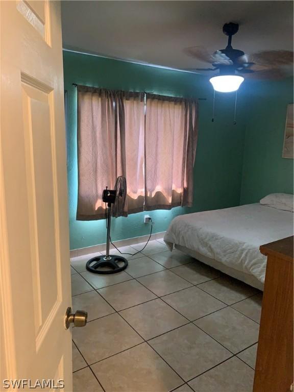 bedroom featuring tile flooring and ceiling fan