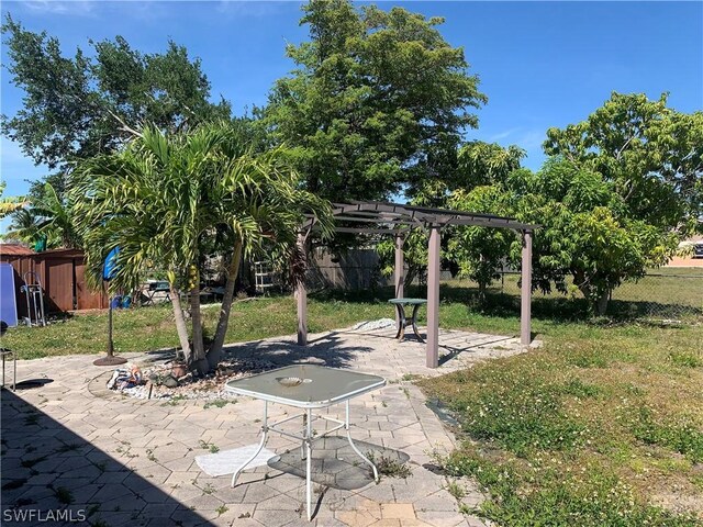 view of yard with a pergola and a patio