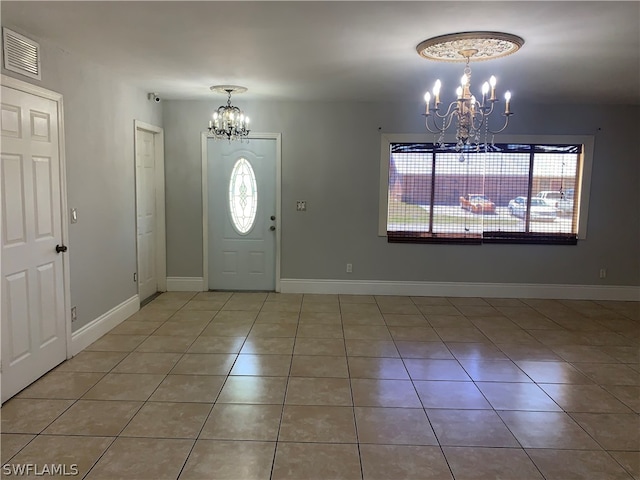 tiled entrance foyer featuring a chandelier