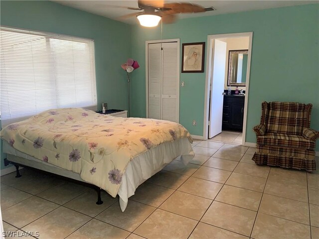 bedroom featuring tile flooring, a closet, and ceiling fan