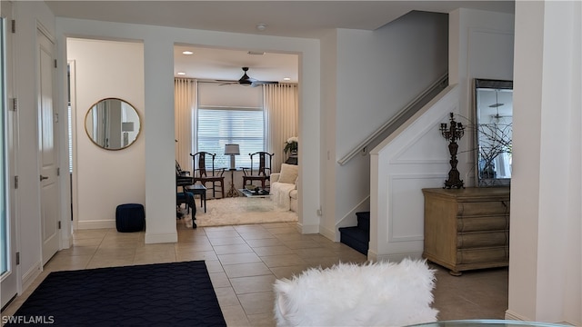 entrance foyer with ceiling fan and light tile patterned flooring