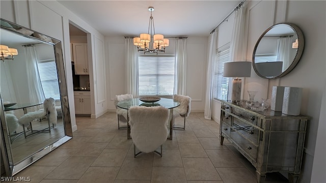 tiled dining area with an inviting chandelier