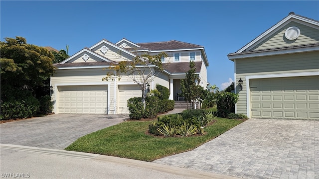 view of front of home featuring a garage and decorative driveway