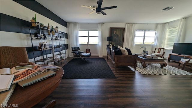 living room with ceiling fan, dark hardwood / wood-style floors, and plenty of natural light