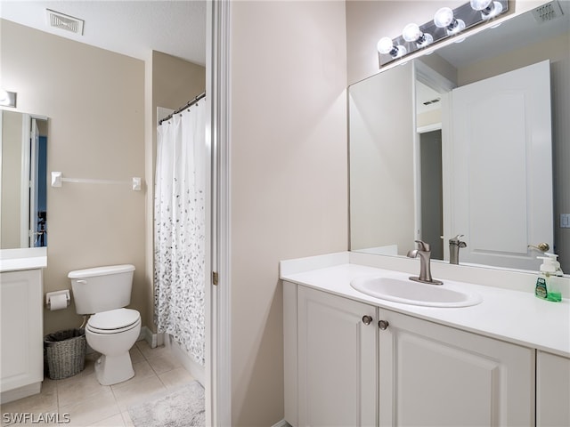 bathroom with a shower with shower curtain, vanity, toilet, and tile patterned floors