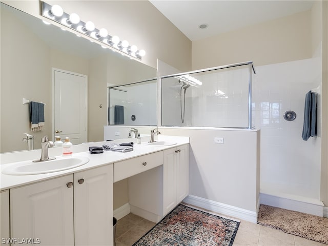 full bathroom with double vanity, tile patterned flooring, walk in shower, and a sink