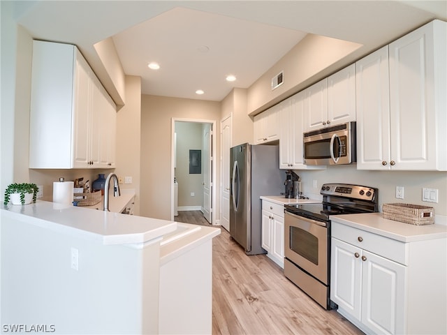 kitchen featuring light wood-style floors, visible vents, appliances with stainless steel finishes, and white cabinets