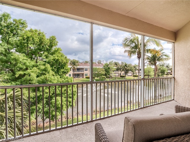 unfurnished sunroom with a water view