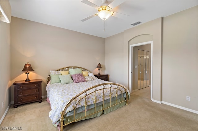 bedroom with light carpet and ceiling fan