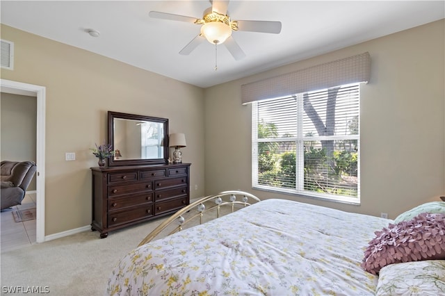 bedroom featuring light colored carpet and ceiling fan