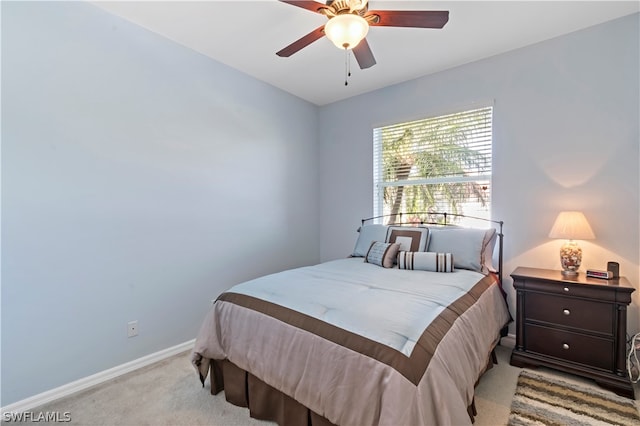 bedroom featuring light colored carpet and ceiling fan