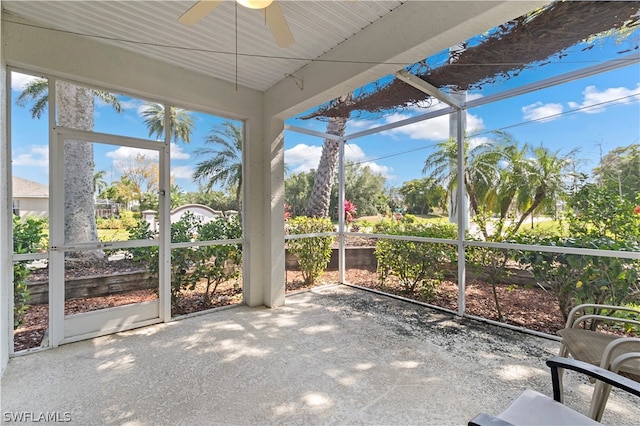 unfurnished sunroom featuring ceiling fan