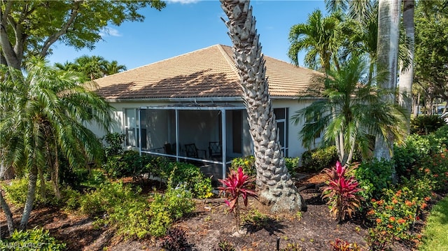 back of property with a sunroom