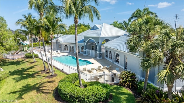 view of pool with a patio area and a lawn