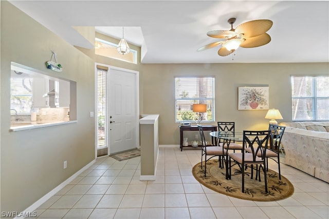 dining area with plenty of natural light, ceiling fan, and light tile floors