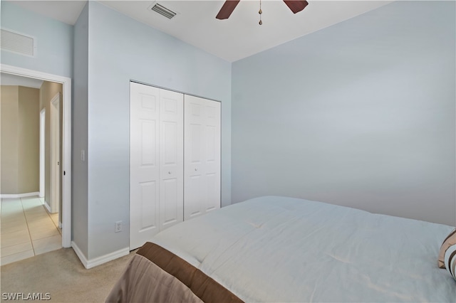 carpeted bedroom with a closet and ceiling fan